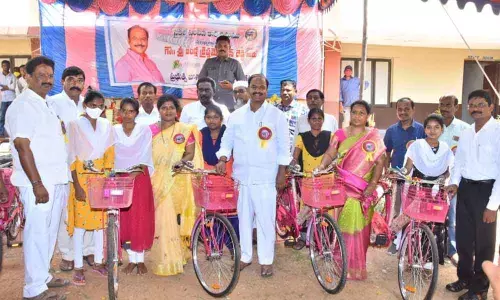 MLA Bandla Krishna Mohan Reddy distributing bicycles to school and college girls in Gadwal on Monday