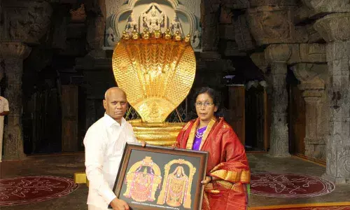 TTD Additional EO A V Dharma Reddy presenting a laminated photo of Lord to Revenue (Endowments) Principal Secretary and Endowments Commissioner Vani Mohan after she took oath as TTD Trust Board ex-officio member, in Tirumala on Monday