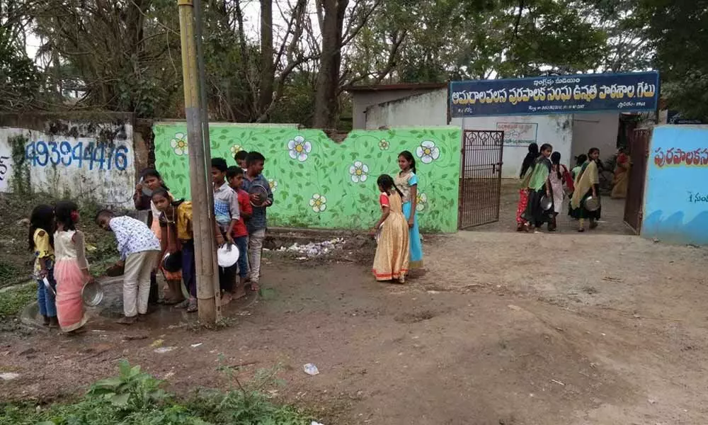 Students are still coming out to clean their plates after midday meal at government school in Amudalavalasa in Srikakulam dist