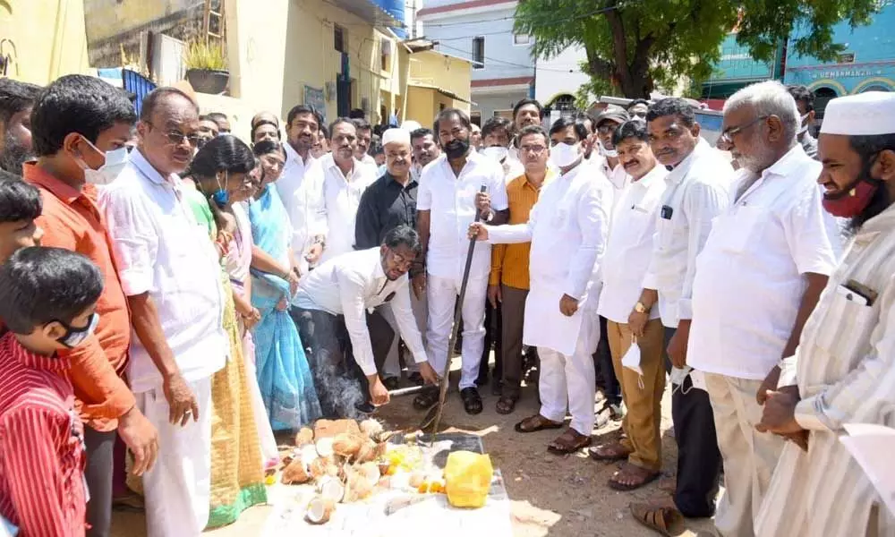 Deputy Chief Minister Amzath Basha laying foundation for CC roads and drains at 28th division in Kadapa on Tuesday.