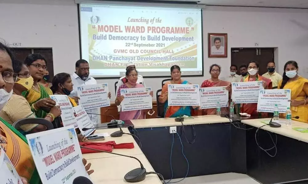 Mayor G Hari Venkata Kumari, corporators and Dhan Foundation members launching a poster on model ward programme in Visakhapatnam on Wednesday