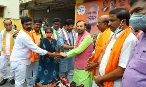 BJP MP Prakash Javadekar distributing saplings to students at Vardarajanagar in Tirupati on Wednesday