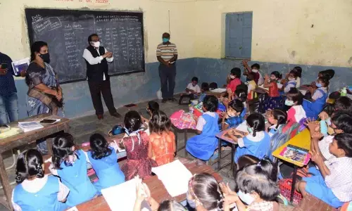 District Collector S Venkat Rao interacting with students of the Government Modern High School in the district headquarters on Wednesday