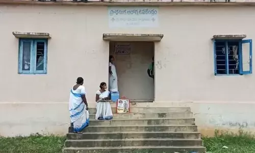 ANM and ASHA workers on the steps of health sub-centre at Kamaram in Mahabubabad