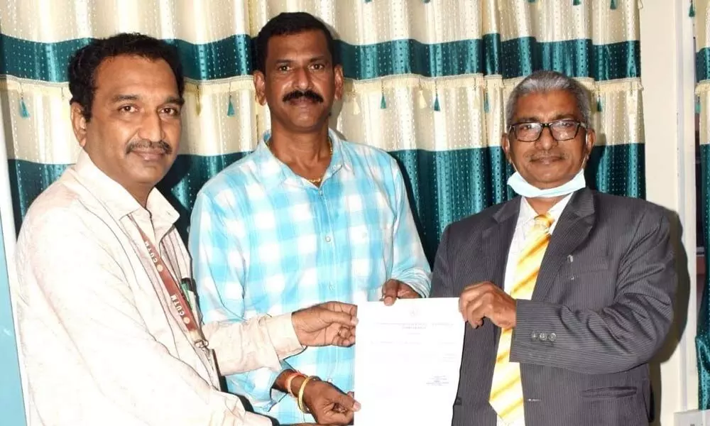 Prof G S N Raju, V-C of Centurion University, hands over appointment letter to Dr Satish Varma