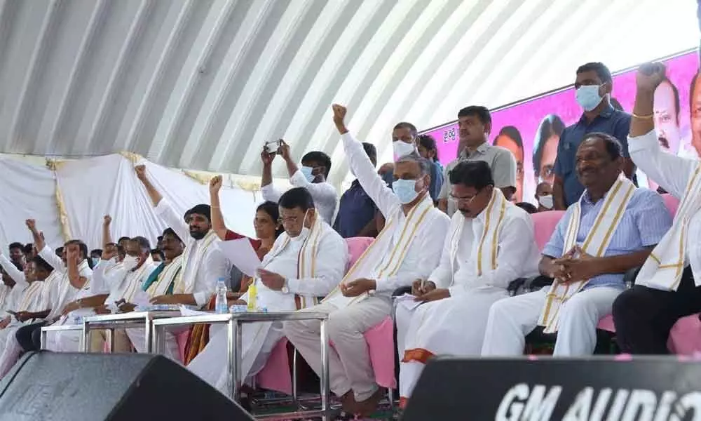 Ministers T Harish Rao and others greet the public at a meeting at Jammikunta in Karimnagar district on Saturday