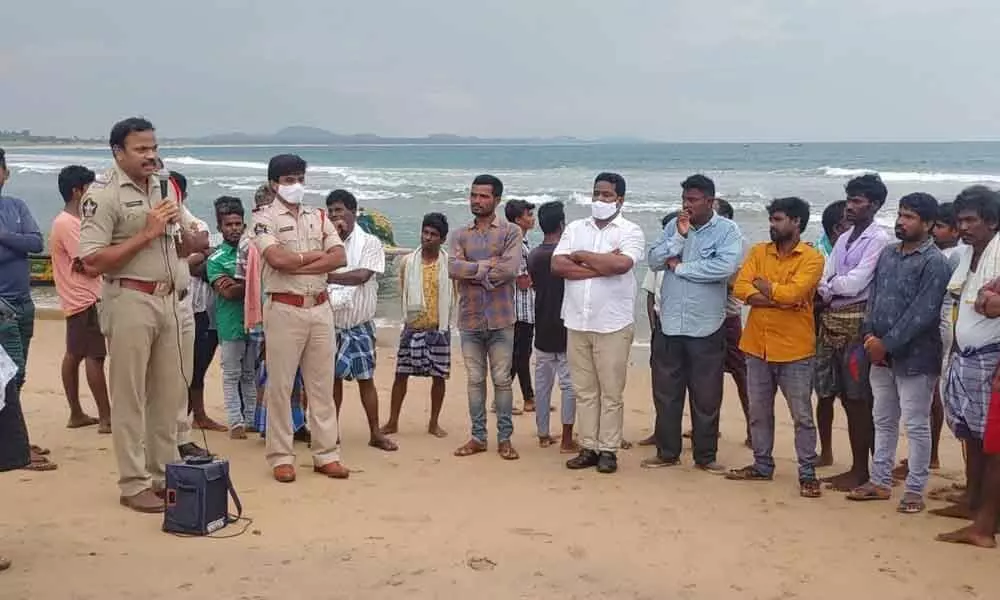 Bhogapuram police along with the Fisheries Department officials cautioning fishermen not to venture into the sea due to the high alert on Cyclone Gulab in Visakhapatnam on Saturday