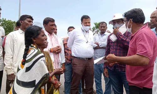 Revenue officials discussing with agitating farmers in Nizamabad on Saturday