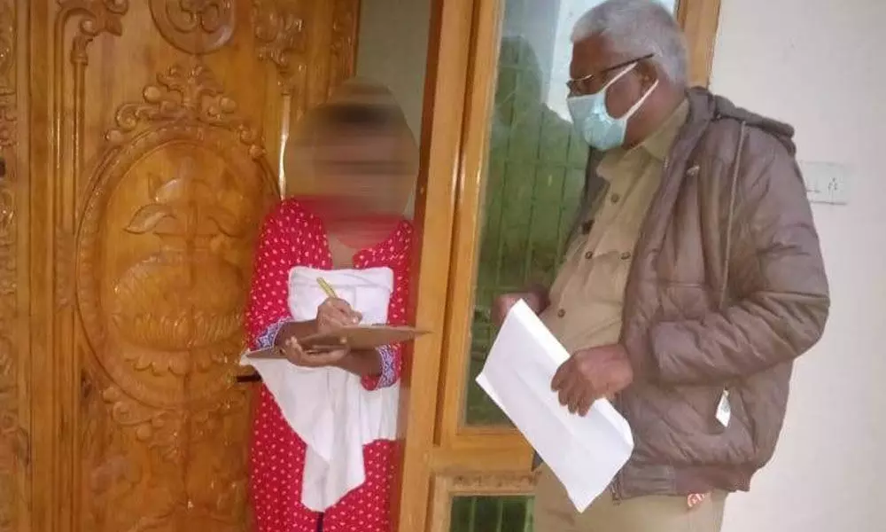 Disha police station ASI Bhaskar Rao taking complaint from the distressed woman at her home in Ongole on Saturday