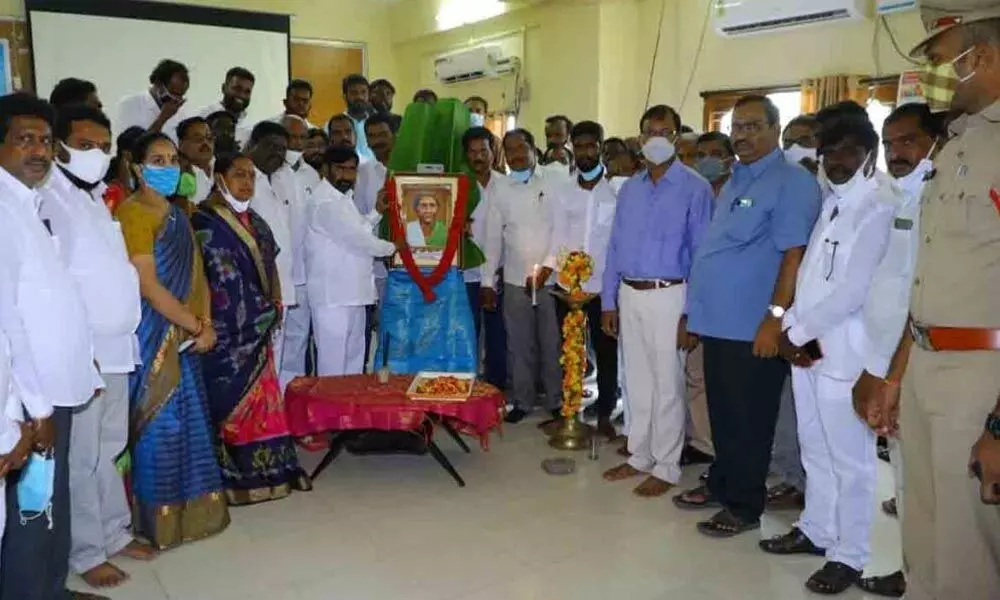 Energy Minister G Jagadish Reddy garlanding the portrait of Chakali Ailamma on her 126th birth anniversary at the district Collectorate in Suryapet on Sunday