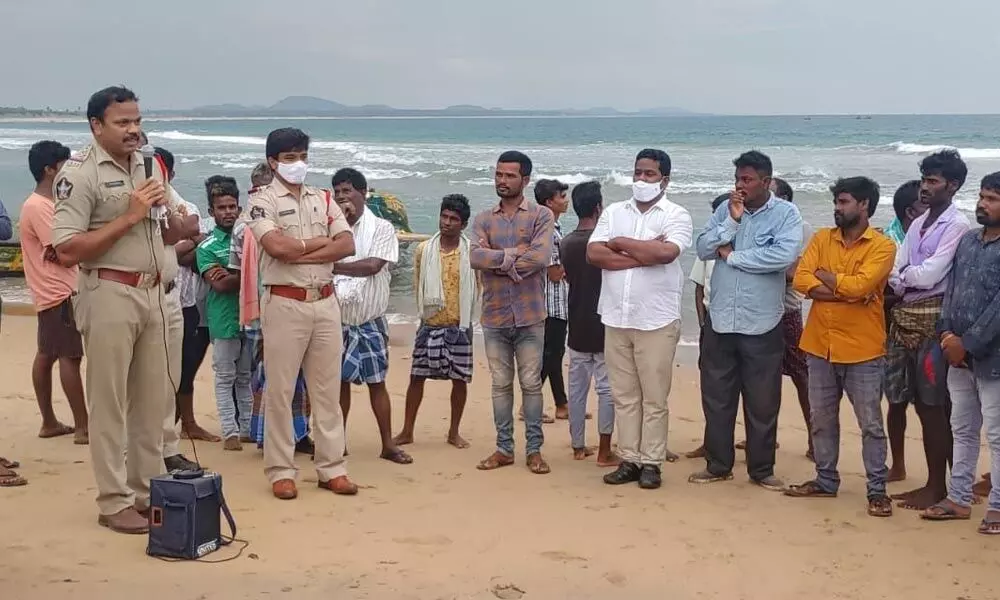 Police alerting villagers in coastal areas on cyclone Gulab in Vizianagaram on Sunday