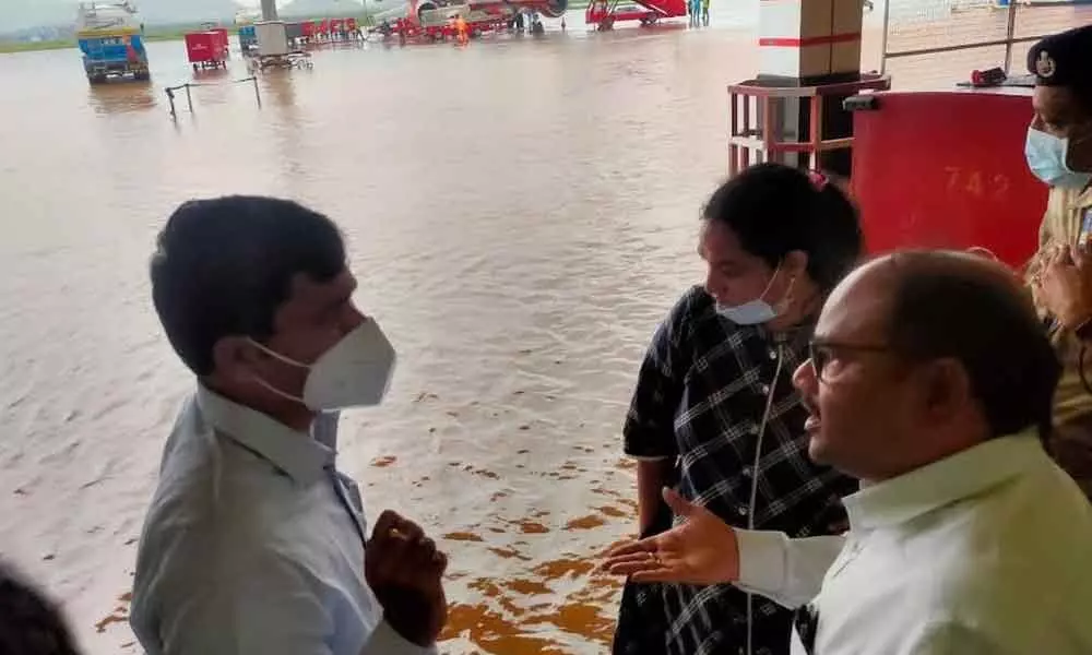 District Collector A Mallikarjuna and GVMC Commissioner G Srijana visiting Visakhapatnam Airport and instructing the officials concerned to clear the rainwater stagnated at the runway on Monday