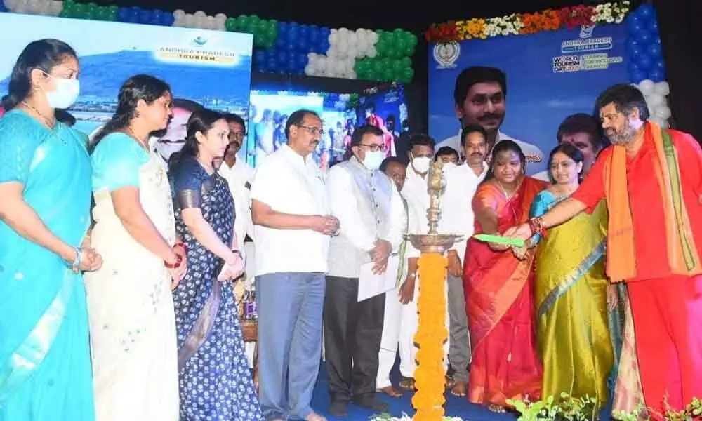 Tourism Minister M Srinivasa Rao lighting the lamp on the occasion of World Tourism Day in Visakhapatnam on Monday