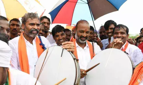 BJP State chief and MP Bandi Sanjay Kumar beating a drum during his Praja Sangrama Yatra at Illantakunta in Sircilla district on Monday