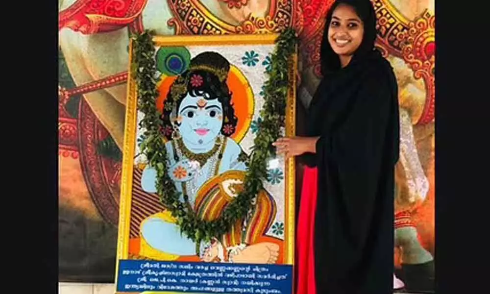 Jasna Salim with her painting of .Little Krishna at Ulanadu Sree Krishna Swamy temple in Pandalam.