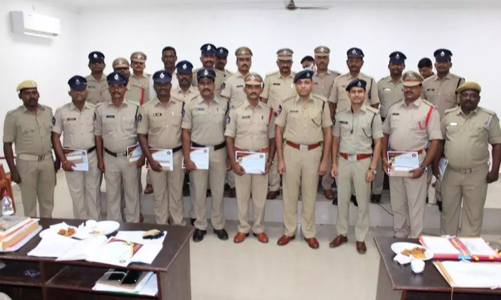 SP Rahul Dev Sarma with policemen who received awards in Eluru on Tuesday