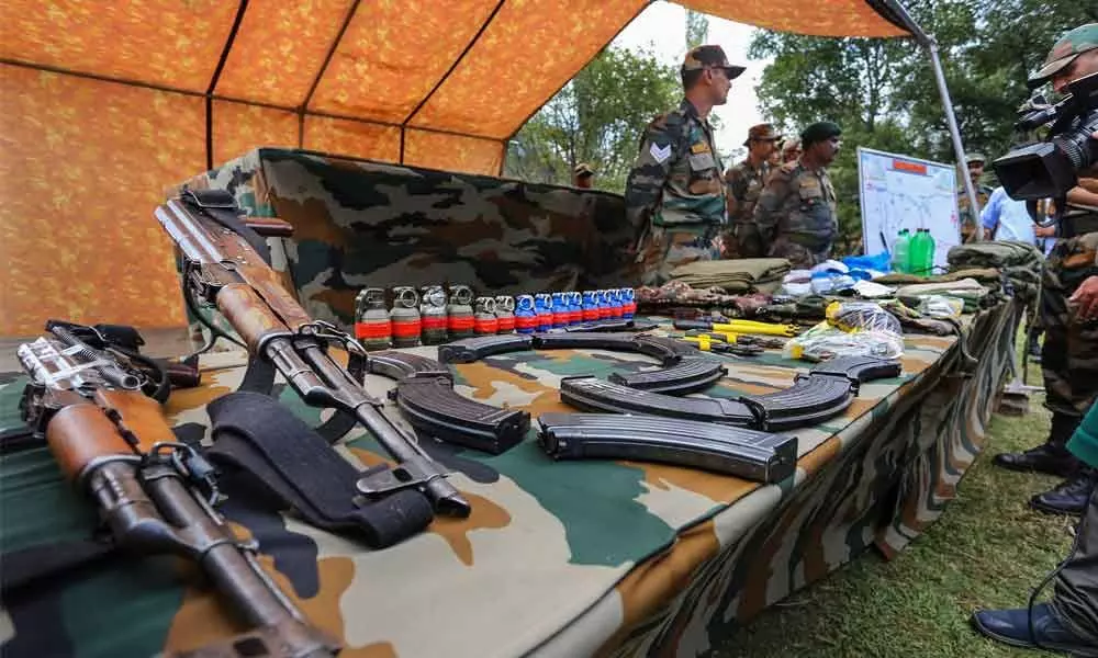 Arms and ammunition recovered from infiltrators who were killed by the Army along LoC during the Uri Operation, on display in Uri on Tuesday