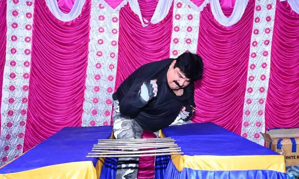 Manoj Chopra breaking iron rods in 15 seconds at a show at Gooty in Anantapur district on Tuesday