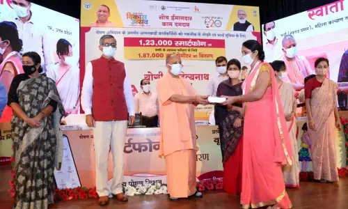 Yogi Adityanath presents smartphones to Anganwadi workers