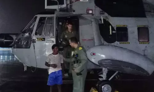 The rescued shepherd with Navy officials at INS Dega in Visakhapatnam