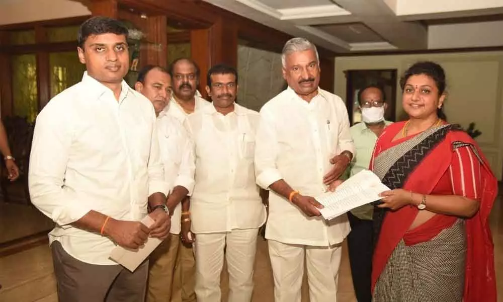 Nagari MLA R K Roja submitting a petition against her rival group to the Minister for Panchayat Raj, Peddireddi Ramachandra Reddy, recently.