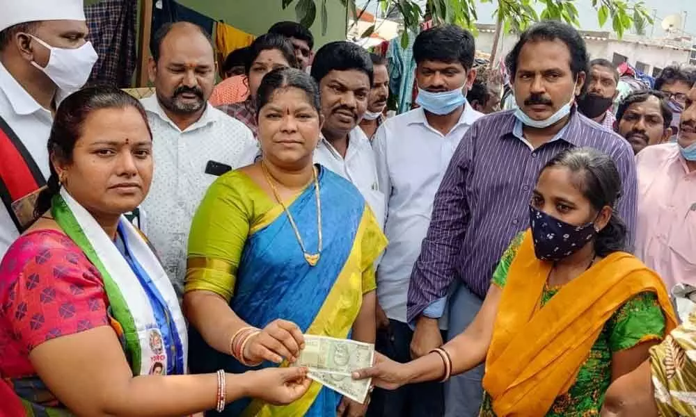 Mayor G Hari Venkata Kumari distributing compensation to the families of victims affected by Cyclone Gulab in Visakhapatnam on Wednesday