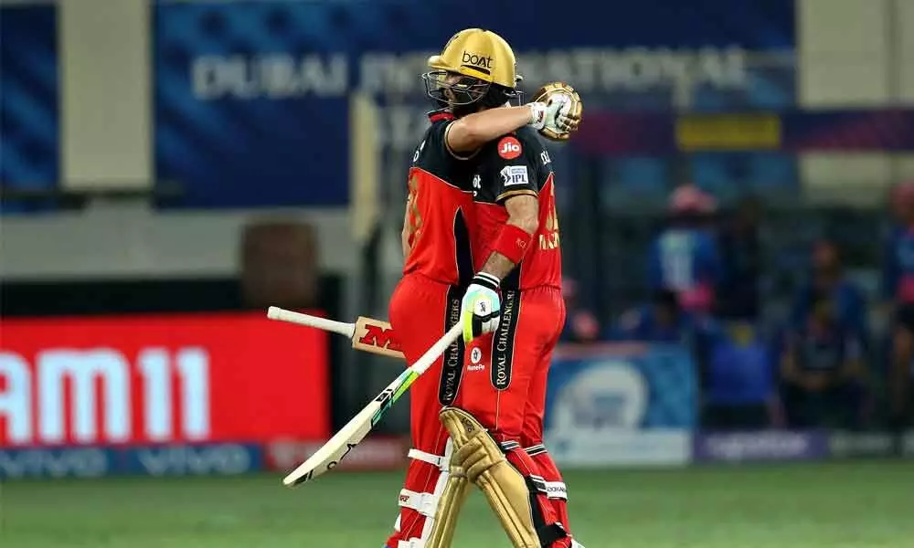 AB de Villiers and Glenn Maxwell of Royal Challengers Bangalore celebrate the win against Rajasthan Royals during the Vivo IPL match held at the Dubai International Stadium in Dubai on Wednesday