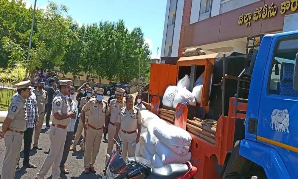 Police with the seized ganja in Kakinada on Sunday