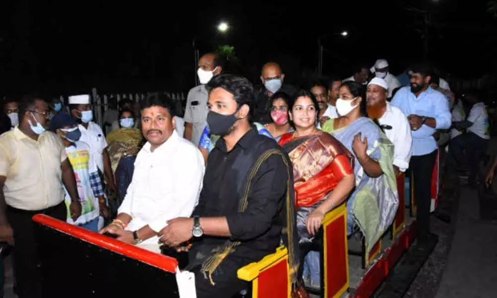 Endowments Minister Velampalli Srinivas, Municipal Commissioner Prasanna Venkatesh enjoy heritage train ride on Gandhi Hill in Vijayawada on Saturday night
