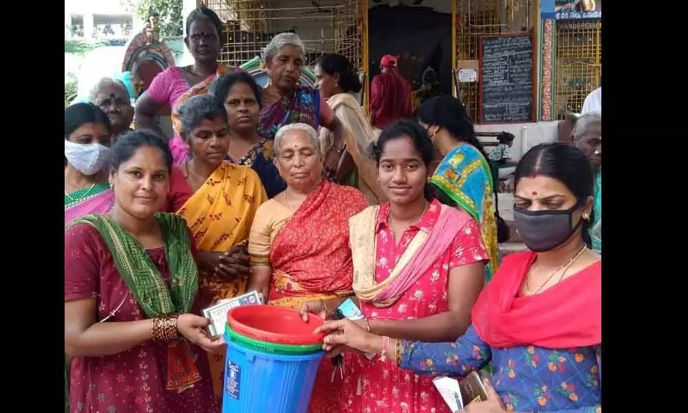 18th division corporator N Indu distributing dustbins to the residents in Chittoor on Sunday