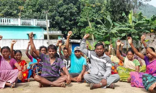 Tribals staging a protest at Kotnapalle in Ravikamatham mandal in Visakhapatnam on Sunday.