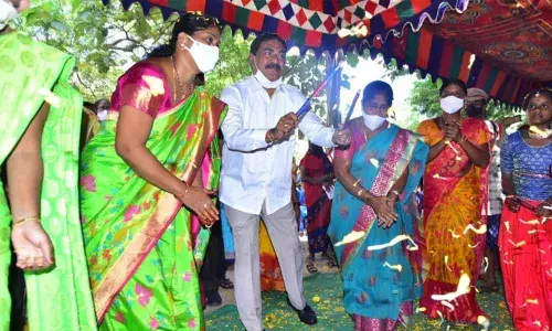Minister for Panchayat Raj Errabelli Dayakar Rao playing kolatam with women at the Bathukamma saree distribution programme held at the ZP High school at Thorrur in Mahabubabad district on Sunday