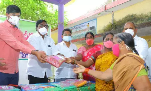 Minister for Transport Puvvada Ajay Kumar distributing Bathukamma sarees  at Raghunadhapalem on Sunday