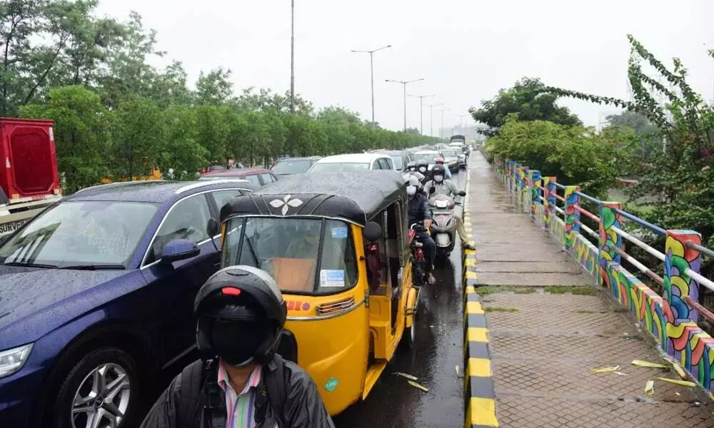 Commuters forced to stand in rain as the CM convoy passed through at Khairatabad, in Hyderabad on Tuesday