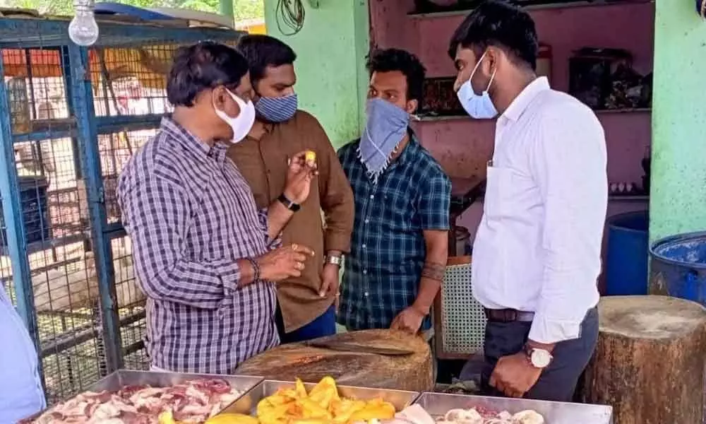Officials inspecting a chicken shop at Singh Nagar in Vijayawada on Tuesday