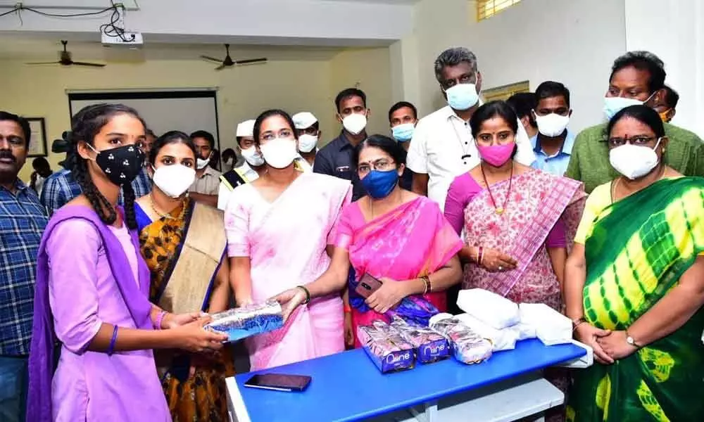 Sanitary napkins being distributed to girls at a programme in Raptadu in Anantapur district on Tuesday