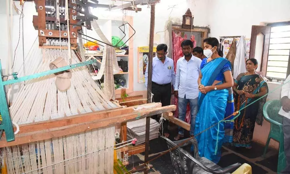 District Collector Valluru Kranthi interacting with a handloom weaver at Weavers’ Colony in Gadwal on Friday