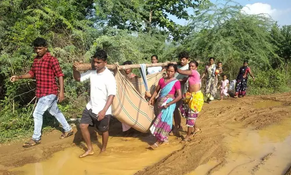 A common sight of carrying pregnant woman in a ‘doli’ for the delivery in the Agency Area of Visakhapatnam