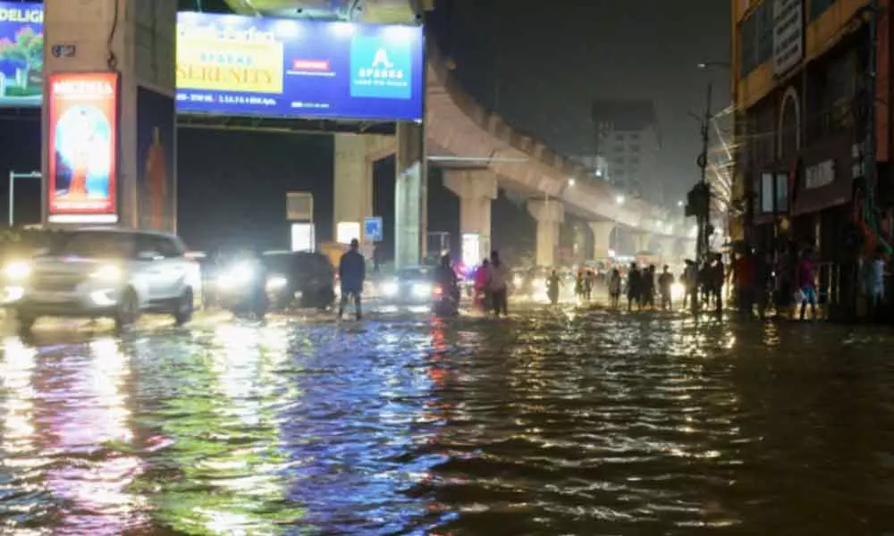 A heavy water flow across the Begumpet main road near the Old Airport due to sudden downpour in the city leading to widespread traffic jams on Saturday. Photo: Ch Prabhu Das