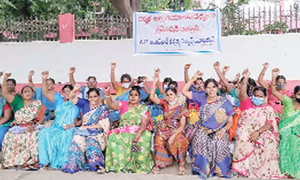 Anganwadi workers and helpers staging a protest at the district collectorate in Ongole on Monday