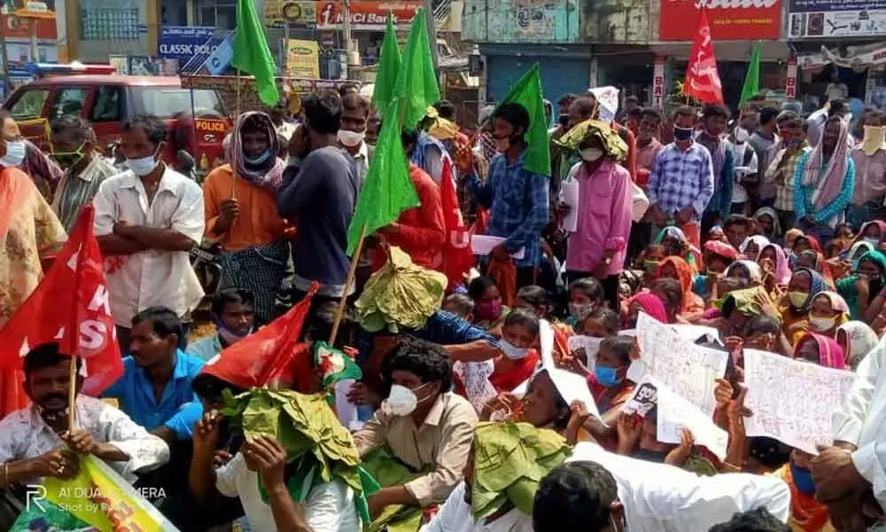 Tribals from Agency area staging a protest in Visakhapatnam on Monday
