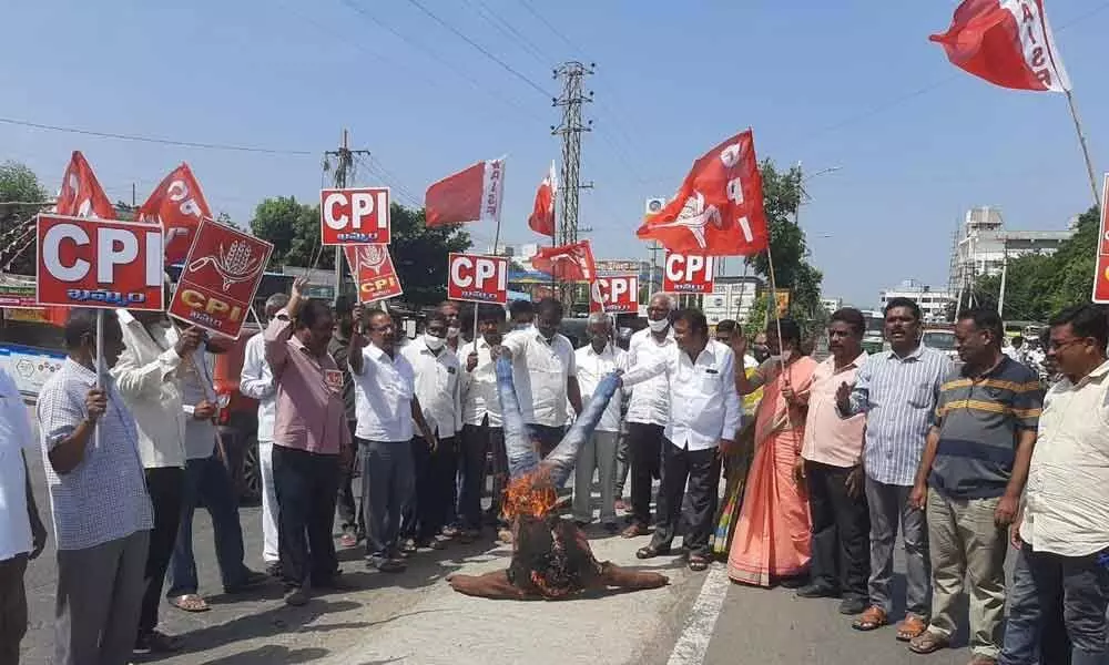 CPI leaders protesting against the Central government over the controversial farm laws in Khammam on Monday