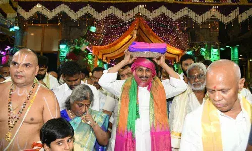 Chief Minister Y S Jagan Mohan Reddy carrying silk clothes to offer them to Lord Venkateswara on the occasion of Garuda Seva as part of Srivari annual Brahmotsavams at Tirumala on Monday