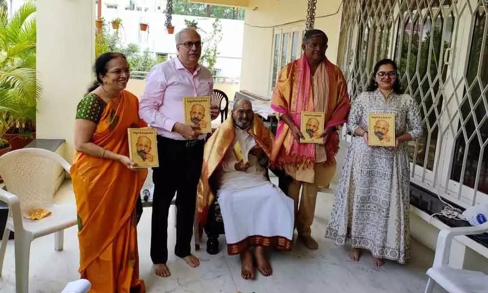 Anamakudu presents his first book to K Visvanath