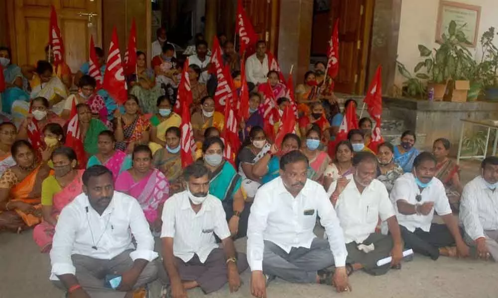Members of AP Medical Contract Workers Union staging a dharna in front of S V Medical College in Tirupati on Saturday