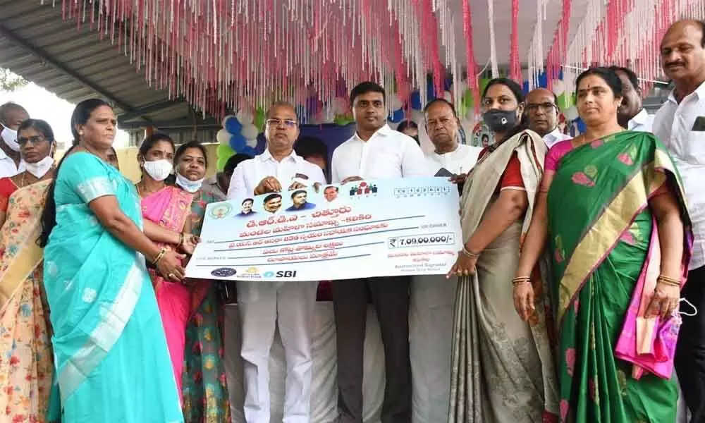 Rajampet MP P Mithun Reddy presenting YSR Aasara cheque to SHG members at Kalikiri on Saturday. Piler MLA C Ramachandra Reddy is also seen