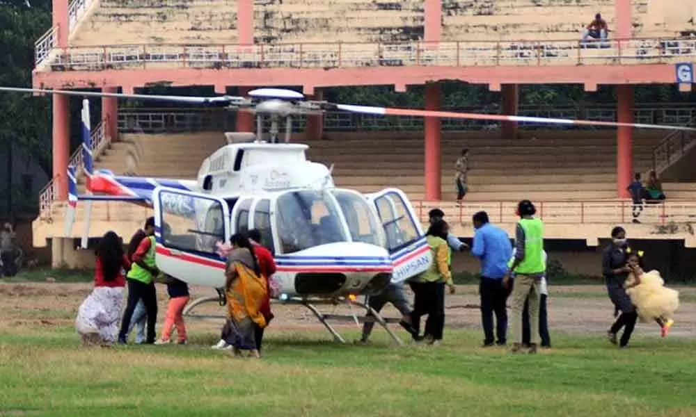 People boarding a helicopter for joyride at IGMC Stadium in Vijayawada on Sunday