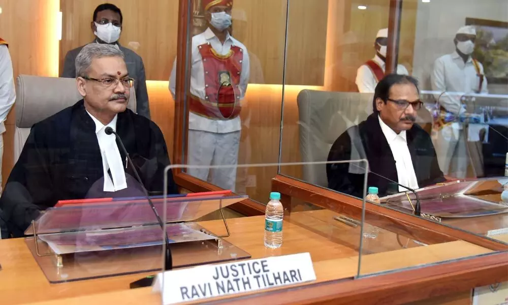 Chief Justice Prasant Kumar Mishra of Andhra Pradesh High Court administering the oath to Justice Ravi Nath Tilhari (left) in the first court hall of AP High Court in Amaravati on Monday