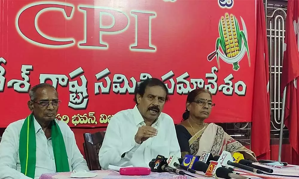 CPI state secretary K Ramakrishna addresses the media in Vijayawada on Monday. AIKS national vice-president Ravula Venkaiah and party Krishna district secretary Akkineni Vanaja are also seen.