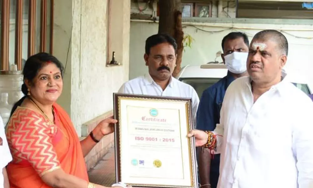 Tourism Minister M Srinivasa Rao presenting ISO certification of Sri Kanaka Mahalakshmi Devasthanam to the temple EO Jyothi Madhavi in Visakhapatnam on Monday
